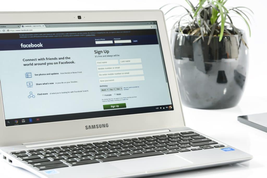 A photo of a laptop screen with the Facebook login page.